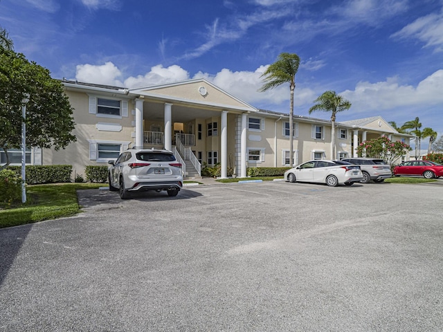 view of building exterior with uncovered parking