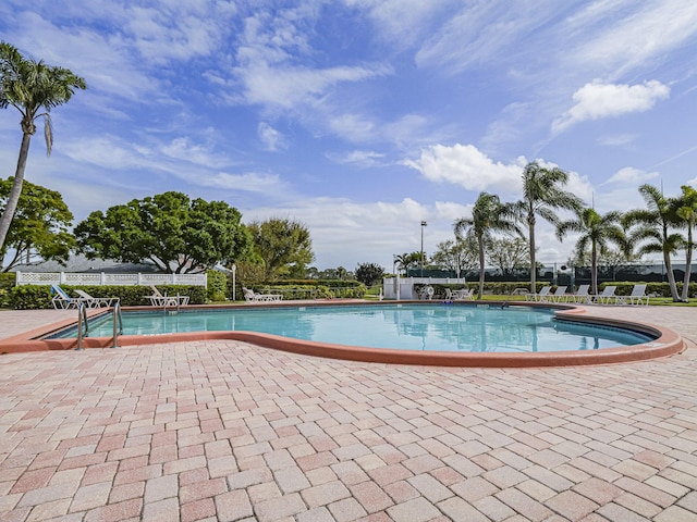 community pool with a patio area