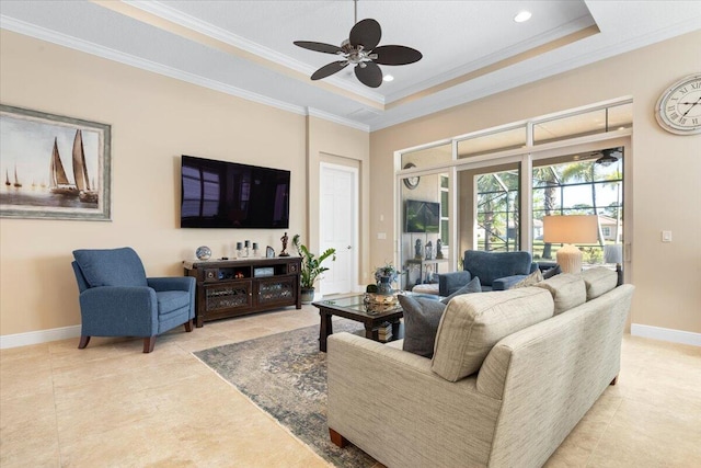 living area with baseboards, a tray ceiling, crown molding, and light tile patterned flooring