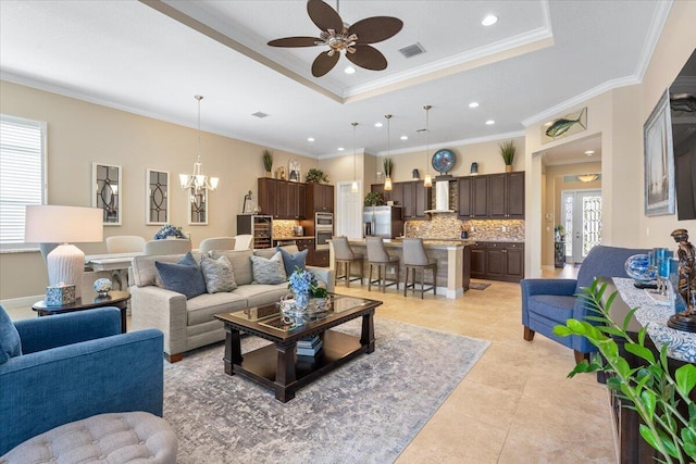 living room with a healthy amount of sunlight, visible vents, and a tray ceiling