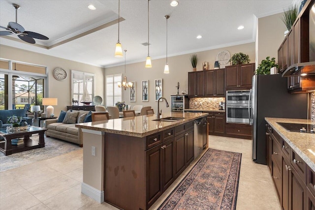 kitchen with decorative backsplash, ornamental molding, light stone countertops, stainless steel appliances, and a sink