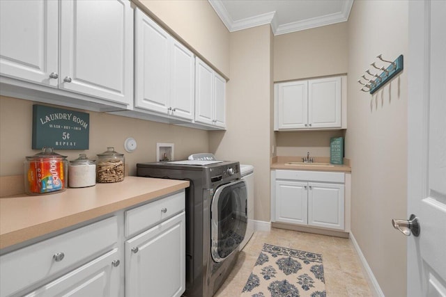 clothes washing area featuring washing machine and dryer, a sink, baseboards, cabinet space, and crown molding