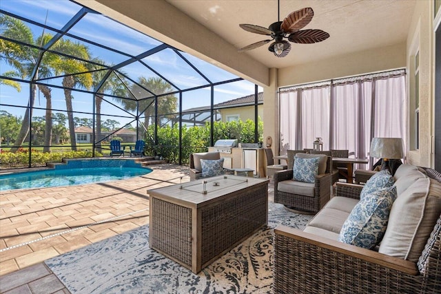 exterior space featuring an outdoor pool, a lanai, an outdoor hangout area, and exterior kitchen