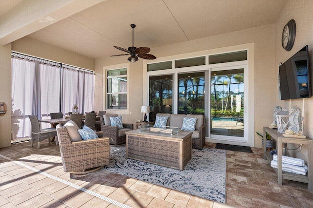 view of patio with an outdoor living space and a ceiling fan