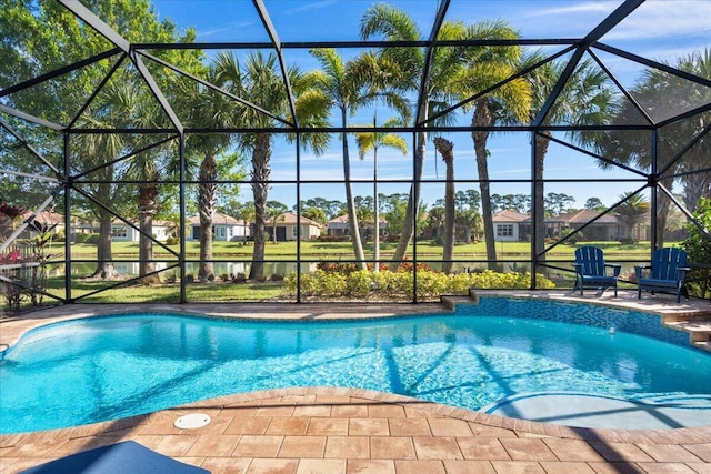 pool with glass enclosure and a patio area