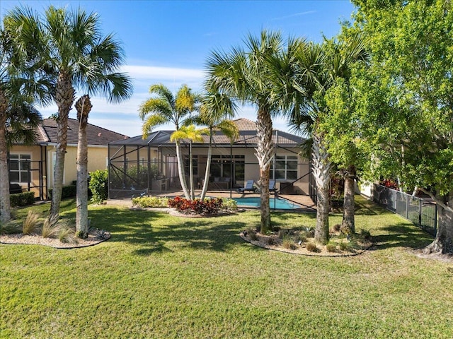 view of yard with a fenced in pool, a lanai, and fence