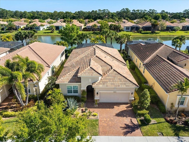 birds eye view of property featuring a water view and a residential view