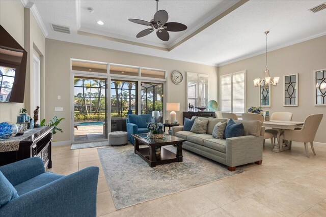 living room with light tile patterned floors, baseboards, visible vents, a raised ceiling, and ornamental molding