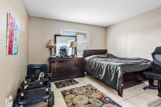 bedroom with light tile patterned floors and a textured ceiling