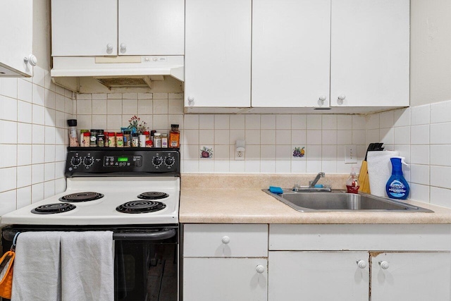 kitchen with a sink, light countertops, white cabinets, under cabinet range hood, and range with electric stovetop