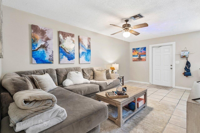 living area with ceiling fan, visible vents, a textured ceiling, and light tile patterned flooring