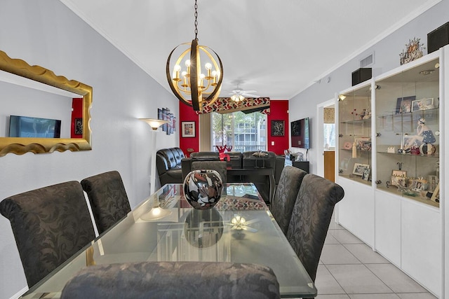 tiled dining area with ornamental molding, lofted ceiling, visible vents, and ceiling fan with notable chandelier