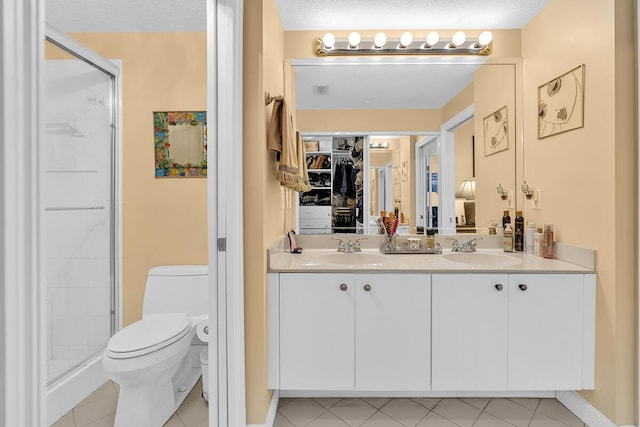 full bath with double vanity, a sink, toilet, and a shower stall