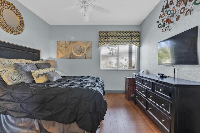 bedroom featuring dark wood finished floors, baseboards, and ceiling fan