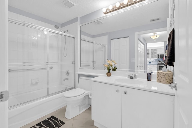 full bath featuring toilet, shower / bath combination with glass door, visible vents, and tile patterned floors