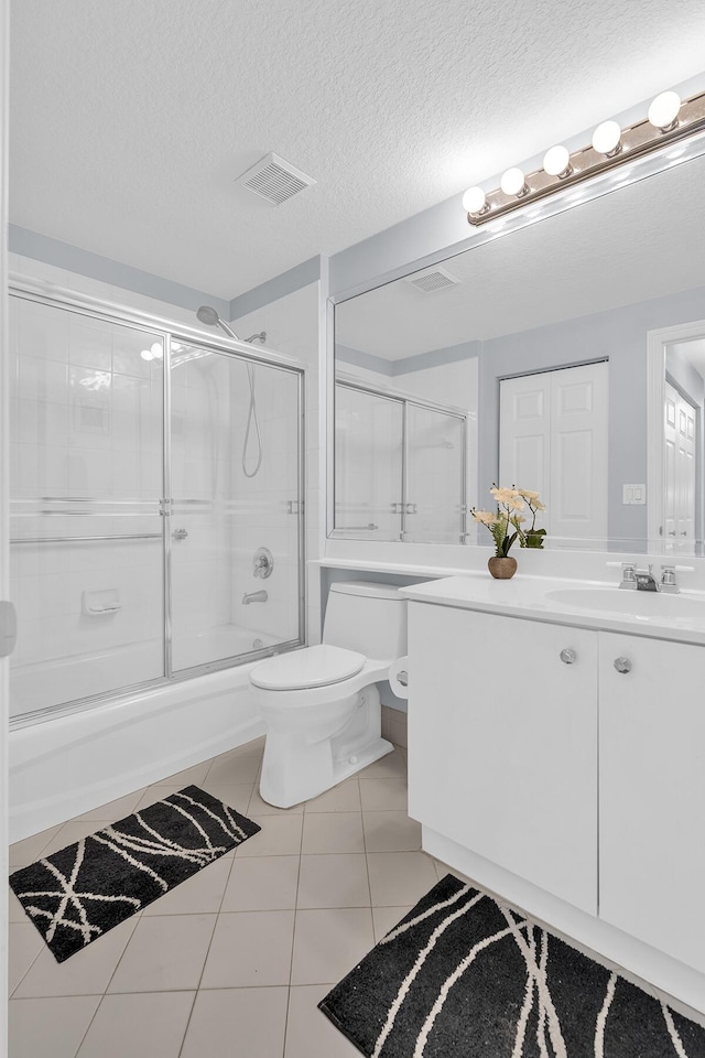 bathroom featuring visible vents, toilet, tile patterned flooring, a textured ceiling, and vanity