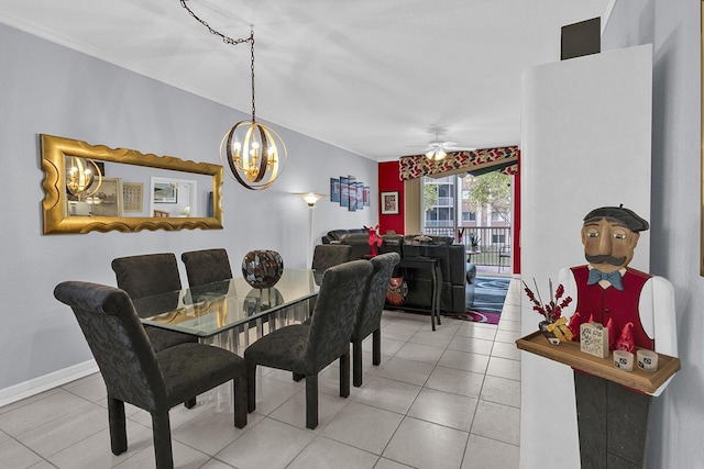 tiled dining space with baseboards, ceiling fan with notable chandelier, and crown molding