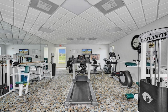 exercise room with visible vents, carpet, and a paneled ceiling