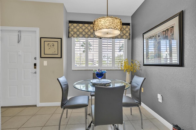 dining space with baseboards and tile patterned floors