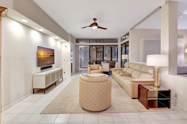 living room featuring ceiling fan, baseboards, and tile patterned flooring