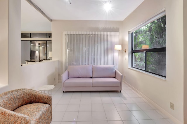 tiled living room featuring baseboards