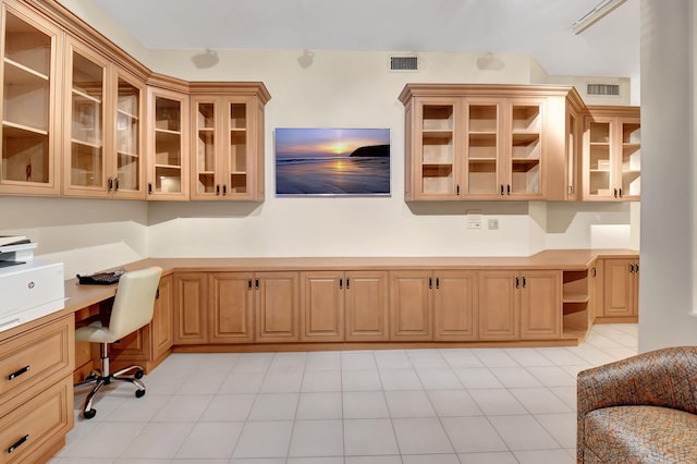 home office with built in desk and visible vents