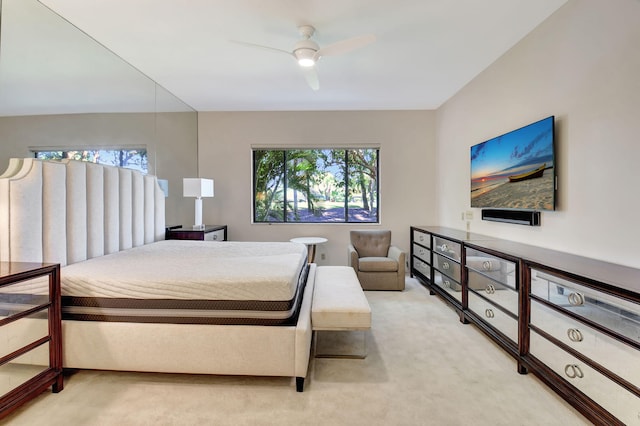 bedroom featuring a ceiling fan and light colored carpet