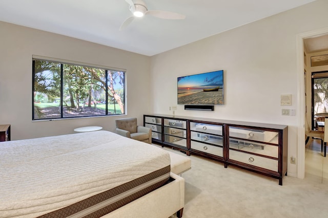 bedroom with light carpet and ceiling fan