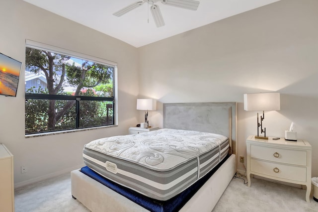 bedroom featuring light carpet, ceiling fan, and baseboards