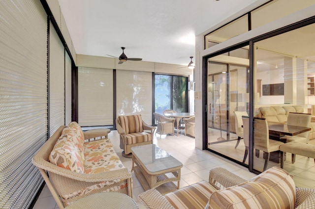 living area with light tile patterned floors and a ceiling fan