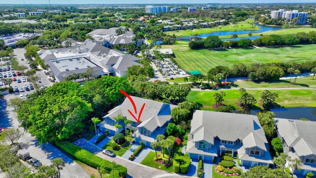 bird's eye view featuring a water view and view of golf course