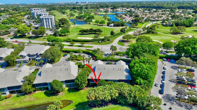 birds eye view of property with view of golf course and a water view