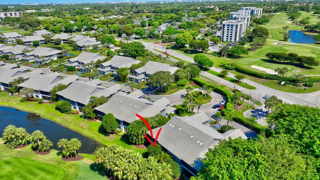 drone / aerial view with a water view and golf course view