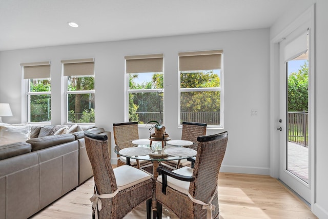 dining space featuring recessed lighting, baseboards, and light wood finished floors