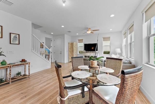 dining space featuring light wood finished floors, stairway, recessed lighting, and visible vents