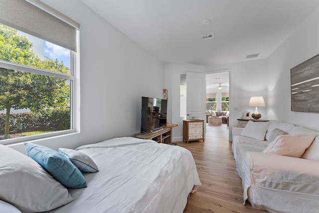 bedroom with wood finished floors and visible vents