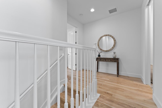 corridor featuring a wainscoted wall, light wood-style flooring, recessed lighting, and visible vents