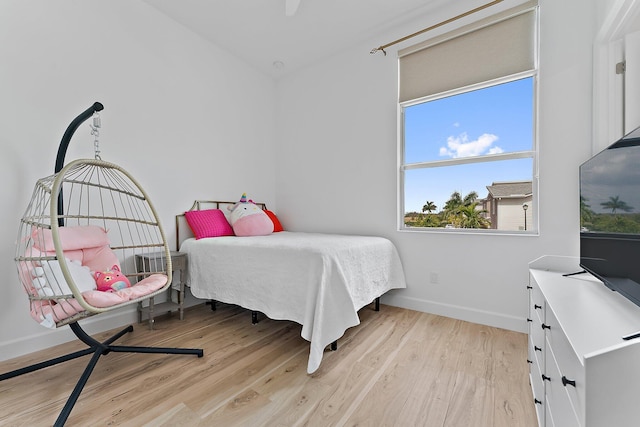 bedroom featuring baseboards and light wood finished floors