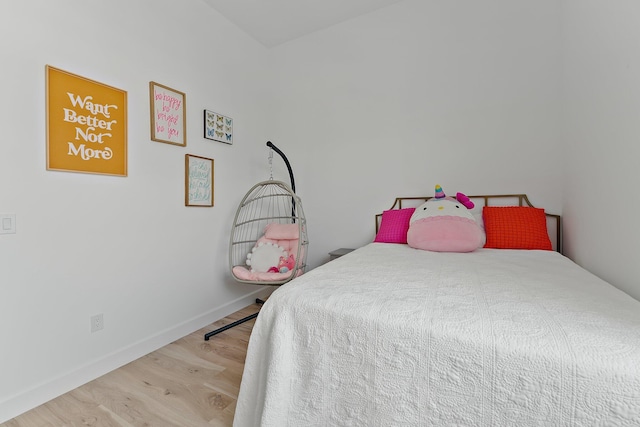 bedroom featuring baseboards and wood finished floors