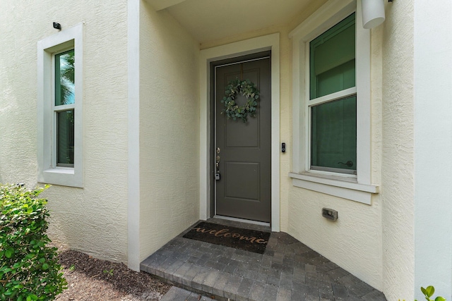 doorway to property with stucco siding