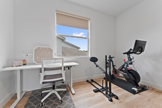 interior space with baseboards and light wood-type flooring