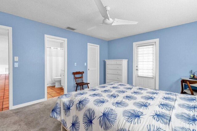 bedroom featuring visible vents, a ceiling fan, carpet, a textured ceiling, and connected bathroom