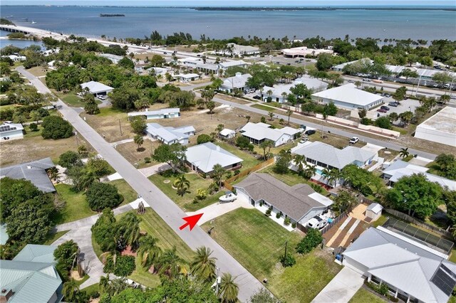 drone / aerial view with a residential view and a water view