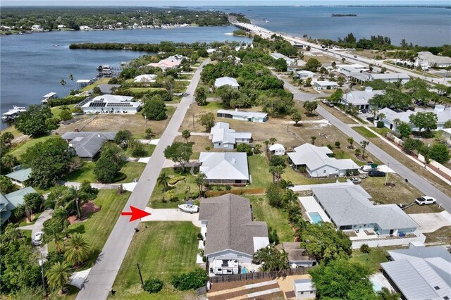 drone / aerial view featuring a water view and a residential view