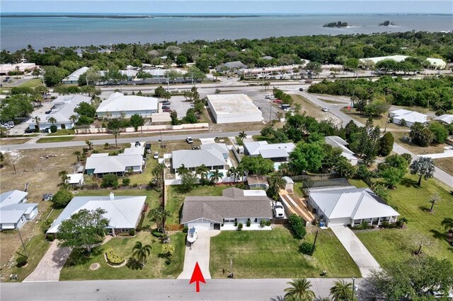 drone / aerial view featuring a residential view and a water view