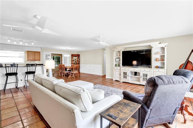 living room featuring ceiling fan and light tile patterned floors