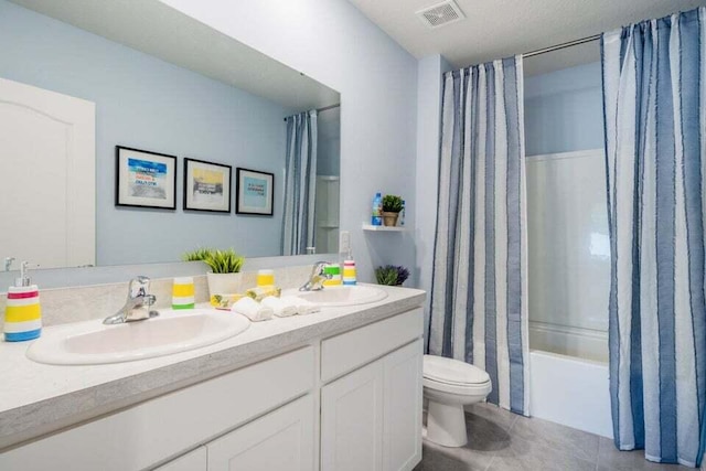 full bathroom featuring toilet, visible vents, a sink, and tile patterned floors