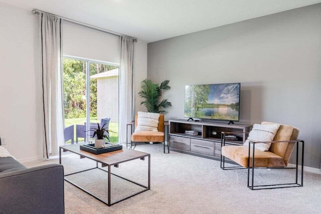 sitting room featuring carpet and baseboards