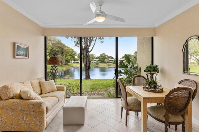 sunroom / solarium with ceiling fan and a water view