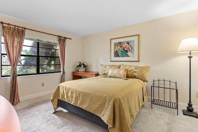 bedroom featuring baseboards and carpet floors